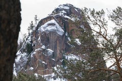 Climbers on the rock Vtoroy Stolb in winter stock photos Climbers on the rock Vtoroy Stolb in winter stock photos