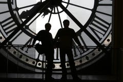 Clock at the Orsay Museum. 2 silhouettes against the clock at the Orsay Museum (Musé¥ d'Orsay stock image Clock at the Orsay Museum. 2 silhouettes against the clock at the Orsay Museum (Musé¥ d'Orsay stock image
