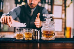 barman hands adding ice and whiskey to modern urban cocktails. Sky bar serving elegant drinks royalty free stock photo barman hands adding ice and whiskey to modern urban cocktails. Sky bar serving elegant drinks royalty free stock photo