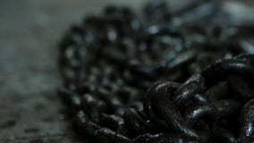 Close up for black chains made of iron in the workshop and industrial background of different machine tools. A pile of stock images