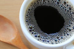 Close Up in black coffee is in a white mug on a brown wooden flo. Or background for design in your work Stock Photos Close Up in black coffee is in a white mug on a brown wooden flo. Or background for design in your work Stock Photos