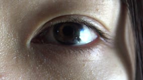 Close-up brown Eye Opens, Detail Pupil Dilates Woman Asian ethnicity in 4K stock video Close-up brown Eye Opens, Detail Pupil Dilates Woman Asian ethnicity in 4K stock video