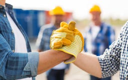 Close up of builders hands making handshake stock photo Close up of builders hands making handshake stock photo