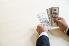 Close Up Business Man Hands Count Hundred Dollar Bills with the stock photo Close Up Business Man Hands Count Hundred Dollar Bills with the stock photo