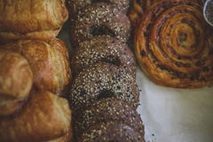 Close-up of cinnamon and raisin curl buns, fresh muffins sprinkled with powdered sugar. stock images Close-up of cinnamon and raisin curl buns, fresh muffins sprinkled with powdered sugar. stock images