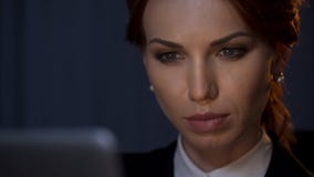 Close up of confident businesswoman looking at laptop screen in company office stock images Close up of confident businesswoman looking at laptop screen in company office stock images
