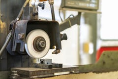 Close up cutting or grinding wheel during rotating or working with product on high accuracy and automatic surface horizontal stock photo Close up cutting or grinding wheel during rotating or working with product on high accuracy and automatic surface horizontal stock photo
