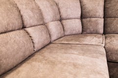 Close-up of an expensive soft textile sofa of beige color with brown shades. Interior Background royalty free stock photography Close-up of an expensive soft textile sofa of beige color with brown shades. Interior Background royalty free stock photography