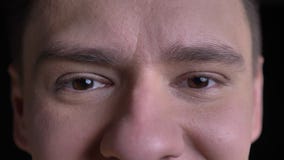 Close-up eye-portrait of middle-aged caucasian man smiling into camera on black background. stock video Close-up eye-portrait of middle-aged caucasian man smiling into camera on black background. stock video