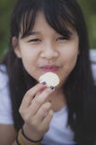 Close up face of asian teenager eating snack food with happiness face royalty free stock image Close up face of asian teenager eating snack food with happiness face royalty free stock image