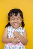 Close Up Face Of Asian Kid Toothy Smiling Facial Face With Happiness Emotion On Yellow Wall Use For Children Lovely Emotion And De Stock Image