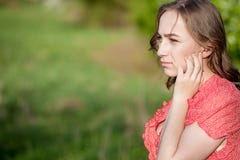 Close-up Of Female Hands Putting Hearing Aid In Ear. Modern digital in the ear hearing aid for deafness and the hard of hearing royalty free stock photography Close-up Of Female Hands Putting Hearing Aid In Ear. Modern digital in the ear hearing aid for deafness and the hard of hearing royalty free stock photography