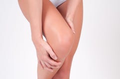 Close-up of female hands touching leg, feeling pain in knee. stock photography Close-up of female hands touching leg, feeling pain in knee. stock photography