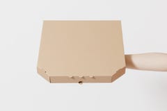 Close up female holds in hand italian pizza in clear empty blank cardboard brown flatbox, food order pizza box isolated royalty free stock images Close up female holds in hand italian pizza in clear empty blank cardboard brown flatbox, food order pizza box isolated royalty free stock images