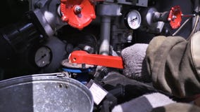 Close-up of fire truck equipment. Scene. Fireman turns red valves on fire truck. Concept of fire royalty free stock photo Close-up of fire truck equipment. Scene. Fireman turns red valves on fire truck. Concept of fire royalty free stock photo