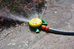 Close up on garden watering system. Water sprinkler. Close up on garden watering system. Water sprinkler in spring Royalty Free Stock Photography Close up on garden watering system. Water sprinkler. Close up on garden watering system. Water sprinkler in spring Royalty Free Stock Photography
