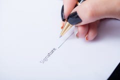 Close Up Girl Hand Putting Signature On Document. She Situating Stock Photo