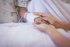 Close up hand of parent holding hand of child in hospital. Retro Stock Images Close up hand of parent holding hand of child in hospital. Retro Stock Images