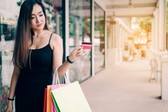 Close up hand of women holding credit card and shopping bags at shopping mall stock image Close up hand of women holding credit card and shopping bags at shopping mall stock image