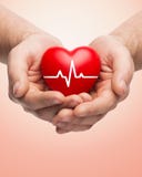 Close up of hands holding heart with cardiogram royalty free stock photography Close up of hands holding heart with cardiogram royalty free stock photography