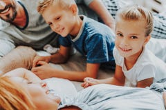 Close up happy girl and boy with parents in bed royalty free stock photo Close up happy girl and boy with parents in bed royalty free stock photo