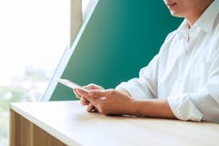 Close-up of happy smiling businessman or employer working on digital tablet and talking on his smartphone. stock image Close-up of happy smiling businessman or employer working on digital tablet and talking on his smartphone. stock image