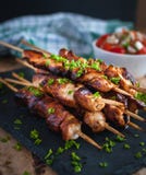 Close-up of homemade honey and beer BBQ chicken skewers with fresh parsley stock photo Close-up of homemade honey and beer BBQ chicken skewers with fresh parsley stock photo
