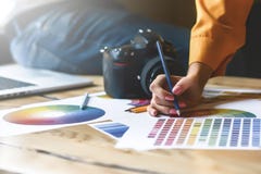Close up hoto of Interior designers teamwork with house building plans on office desk, architects working with many-color palette royalty free stock photography Close up hoto of Interior designers teamwork with house building plans on office desk, architects working with many-color palette royalty free stock photography