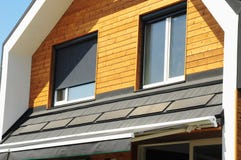 House Blinds Sun Protection Exterior with Solar Panels. Windows in New Modern Passive House Attic Facade Wooden Wall with Shutters stock image House Blinds Sun Protection Exterior with Solar Panels. Windows in New Modern Passive House Attic Facade Wooden Wall with Shutters stock image