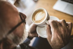 Close Up Image Of Senior Businessman Drinking Coffee. Royalty Free Stock Images