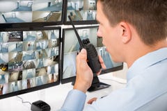 Male Security Guard Talking On Walkie-talkie stock photos Male Security Guard Talking On Walkie-talkie stock photos
