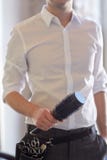 Close up of male stylist with brush at salon stock photography Close up of male stylist with brush at salon stock photography