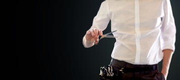 Close up of male stylist with scissors over black stock photos Close up of male stylist with scissors over black stock photos