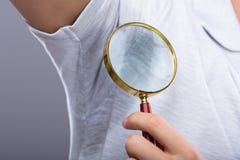 Man With Sweaty Armpit Holding Magnifying Glass royalty free stock photo Man With Sweaty Armpit Holding Magnifying Glass royalty free stock photo