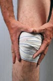 Man with bandaged knee stock photography Man with bandaged knee stock photography