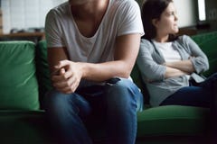 Unhappy couple sitting on couch at home stock photography Unhappy couple sitting on couch at home stock photography