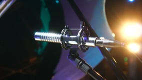 Microphone in concert hall with lights at background stock video Microphone in concert hall with lights at background stock video