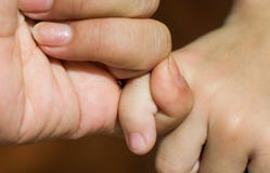 Close up mother finger holding her child finger so tightly, its showing that how much love from her. Stock Image Close up mother finger holding her child finger so tightly, its showing that how much love from her. Stock Image