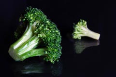 Close Up Of A Green Brocoli Floret Reflecting On Black Royalty Free Stock Image