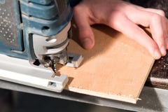 Close Up Of Carpenter`s Hands Working Power Tools For Processing Wood. Power Jigsaw Royalty Free Stock Photo Close Up Of Carpenter`s Hands Working Power Tools For Processing Wood. Power Jigsaw Royalty Free Stock Photo