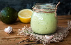 Close-up Of Homemade Creamy Avocado Dressing In A Jar On Wooden Background Royalty Free Stock Photography