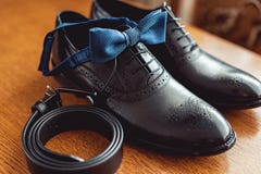 Close Up Of Modern Man Accessories. Blue Bow Tie, Leather Shoes, And Belt. Stock Photo Close Up Of Modern Man Accessories. Blue Bow Tie, Leather Shoes, And Belt. Stock Photo
