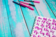 Close Up Of Notebook With Hand Drawn Abc Alphabet Letters And Colorful Pens On Blue Wooden Desk Background Royalty Free Stock Image Close Up Of Notebook With Hand Drawn Abc Alphabet Letters And Colorful Pens On Blue Wooden Desk Background Royalty Free Stock Image