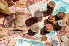 Stacks of coins on paper notes. Banknotes and coins of different countries stock images Stacks of coins on paper notes. Banknotes and coins of different countries stock images