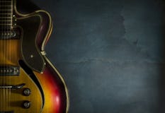 Close-up of old electric jazz guitar on a dark blue background stock photography Close-up of old electric jazz guitar on a dark blue background stock photography