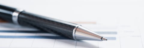 Close-up pen on financial report. Concept of Infomation Data Analysis, Business Investment Analytics and Business Planning. Web stock photography Close-up pen on financial report. Concept of Infomation Data Analysis, Business Investment Analytics and Business Planning. Web stock photography
