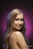 Close up photo of a beautiful blonde smiling model girl with naked shoulders on a dark and pink background stock images Close up photo of a beautiful blonde smiling model girl with naked shoulders on a dark and pink background stock images