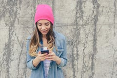 Close-up Photo Of Smiling Hipster Girl Reading Text On Smartphone. She Is Very Happy Because She Got An Invitation To A Party Cell Stock Photo