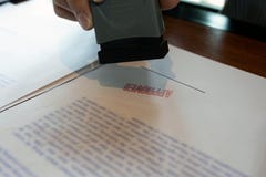 Close-up pictures of the hands of businessmen signing and stamping in approved contract forms royalty free stock photo Close-up pictures of the hands of businessmen signing and stamping in approved contract forms royalty free stock photo