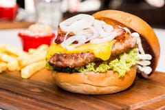 Close up on Pork burger with cheese, vegetable and served with fries stock images Close up on Pork burger with cheese, vegetable and served with fries stock images